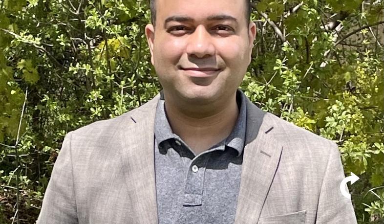 Amol Kapoor smiling with grey jacket on