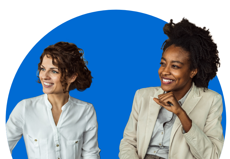 2 happy females smiling at colleagues, in the middle of meeting.